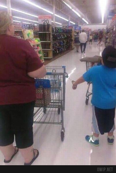 Parents found a way to keep their kid near them while they are in supermarket.