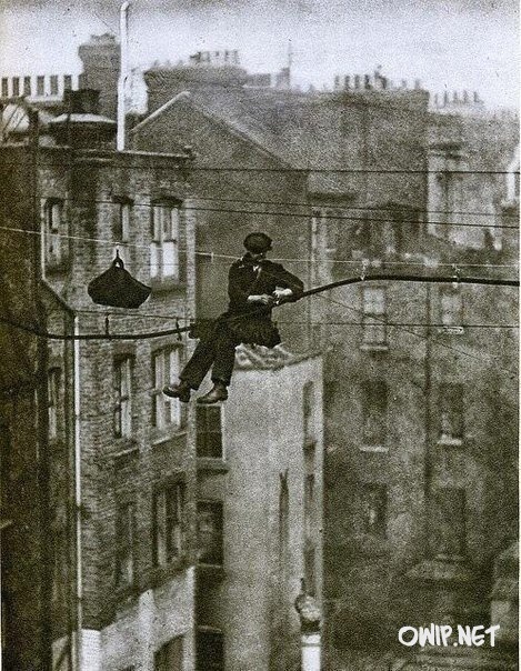 Telephone engineer over the streets of London, 1930
