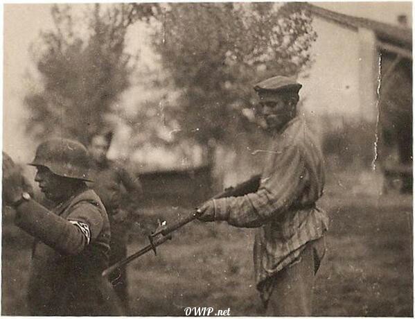 Freed Jew holds a German soldier at gunpoint, 1945