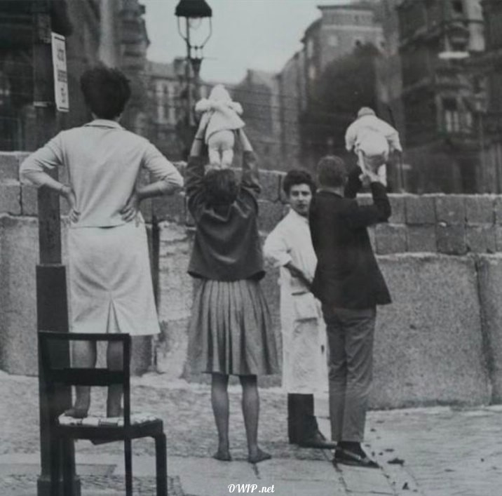 Residents of West Berlin show grandchildren to grandparents in East Berlin, 1961.