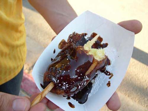 Deep-fried Twinky On A Stick Dipped In Chocolate Syrup
