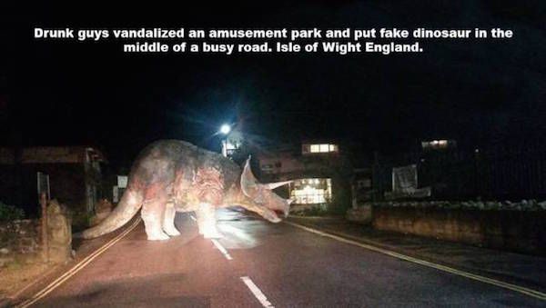 random dinosaur on road isle of wight - Drunk guys vandalized an amusement park and put fake dinosaur in the middle of a busy road. Isle of Wight England.