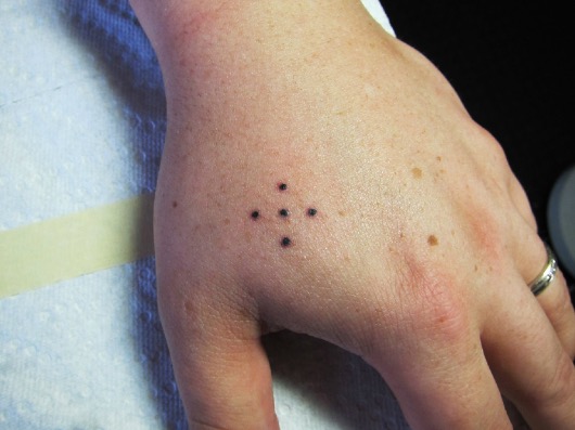 Five dots-This collection of five dots means that the wearer has done prison time