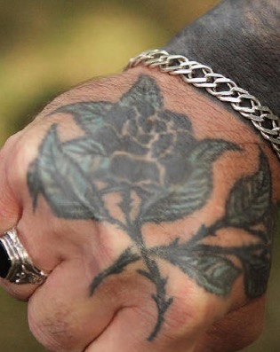 Rose with thorns-This is a prevalent tattoo among Asian or Russian gang members. It means the wearer spent their 18th anniversary in jail.