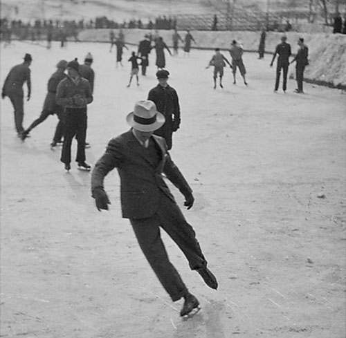 Dude ice skating in a suit in 1937