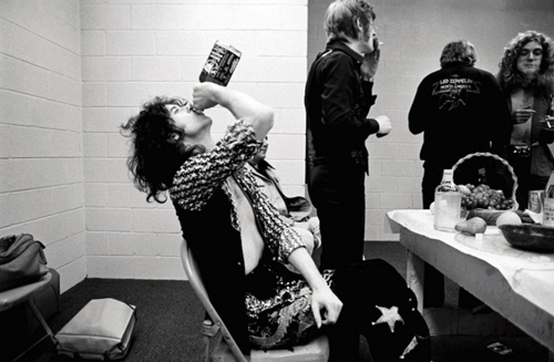 Jimmy Page of Led Zeppelin pounding some Jack Daniels before going on stage, 1970s