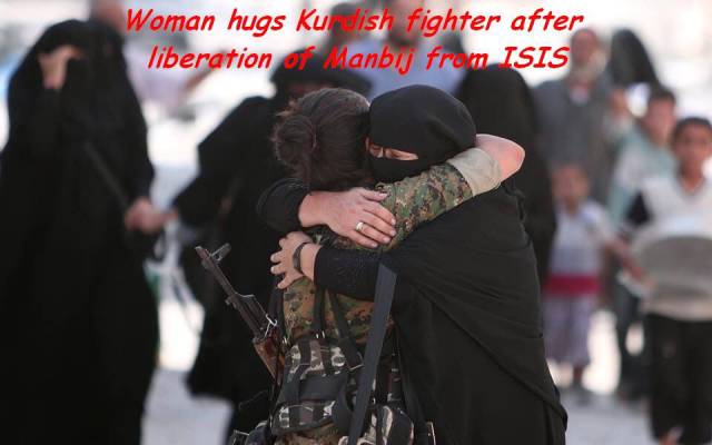 manbij free - Woman hugs Kuish fighter after liberation of Manbij from Isis