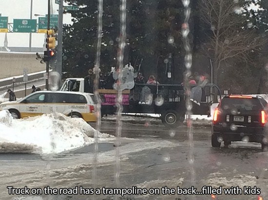 snow - Truck on the road has a trampoline on the back...filled with kids