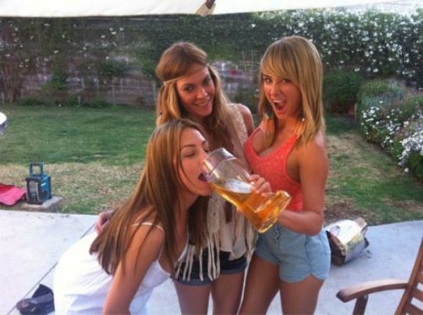 funny picture of 3 girls enjoying a tall glass of beer from a clear boot