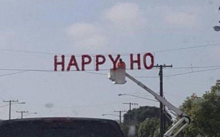 Very funny picture of a Happy Holidays sign being put up but just HAPPY HO is displayed.