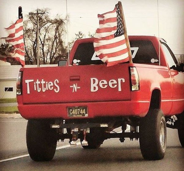 funny picture of red pick-up truck with massive american flags out the back and letters that say Titties and Beer