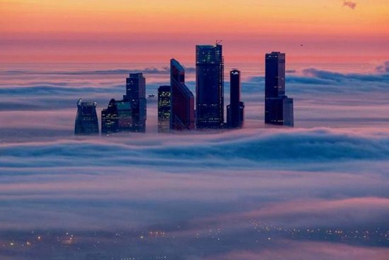 cool pictures of building poking its head out of the clouds