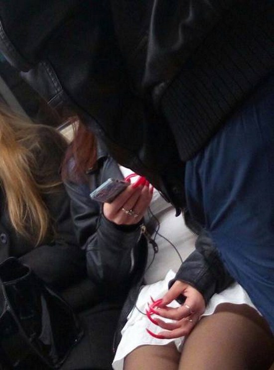 funny picture of a woman with massive nails trying to use a smartphone