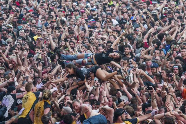 Photograph of someone having a great time crowd surfing at a concert.