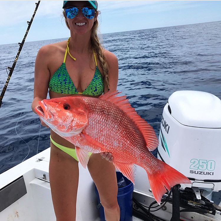 Hot girl holding a red fish.