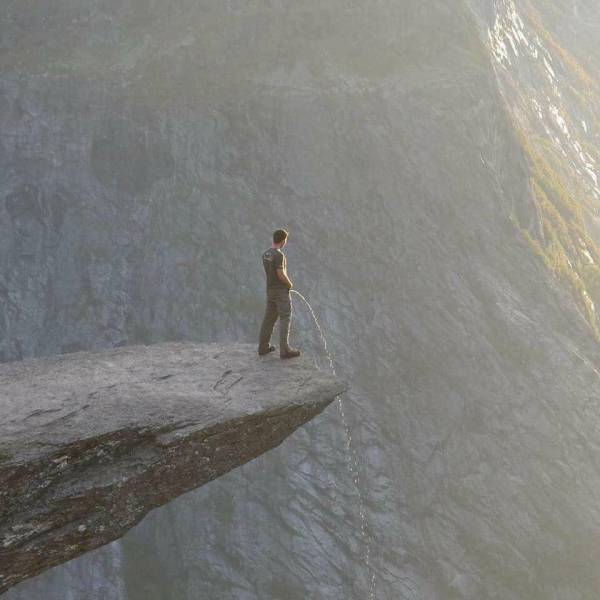 random pic guy peeing off cliff