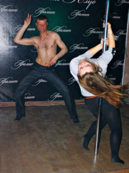 Cringeworthy Russian party pics of shirtless dude dancing while girl twirls around a pole