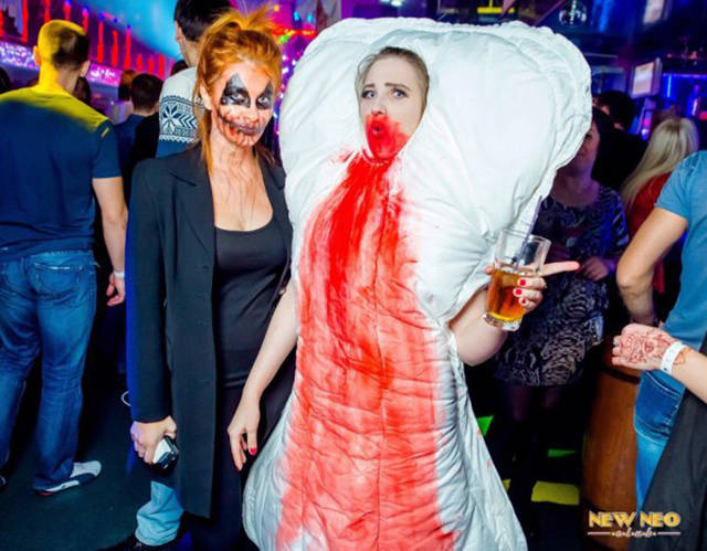 Cringeworthy Russian party pics of red haired girl dressed as goth and woman dress as bloody maxi-pad.
