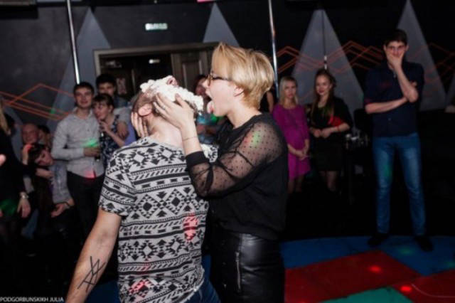 Cringeworthy Russian party pics of woman eating something creamy on the dancefloor