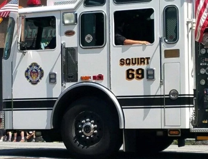 Fire engine with immature name of Squirt 69 painted on the official side of the vehicle.