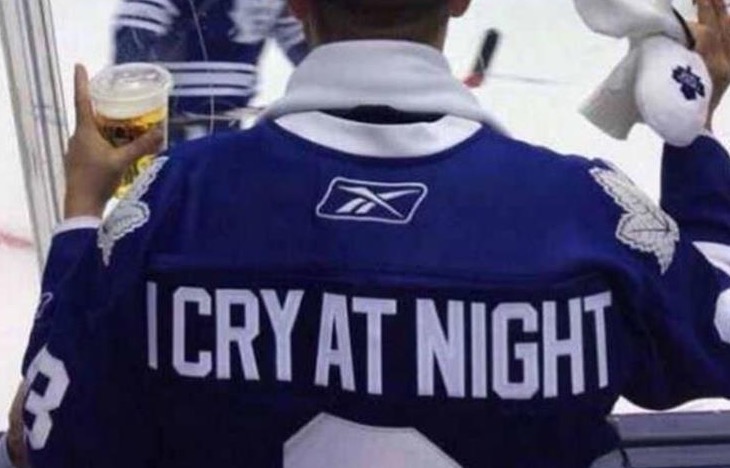 Hockey player with the words I Cry At Night on the back of his starter jacket.