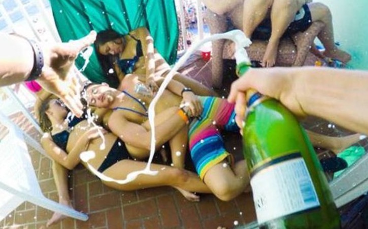 Man passed out and getting hosed down with Champagne