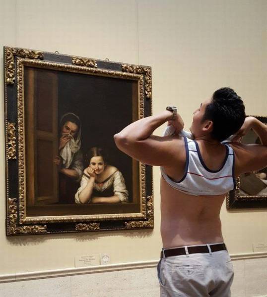Funny picture of man flashing a classical painting in a museum of a couple staring out their window