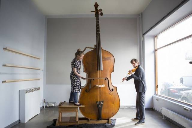 Cool picture of massive Cello and Violin playing in tiny studio space