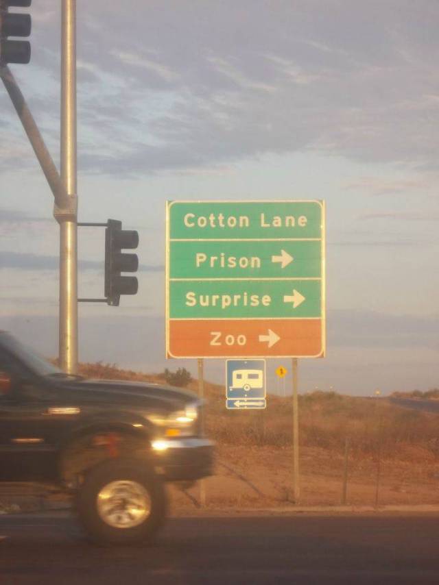 Funny picture of road sign in Arizona of Prison, Surprise and Zoo all in the same direction