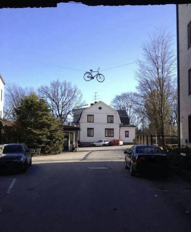 Funny picture of a WTF bike stuck in the electric of phone wires
