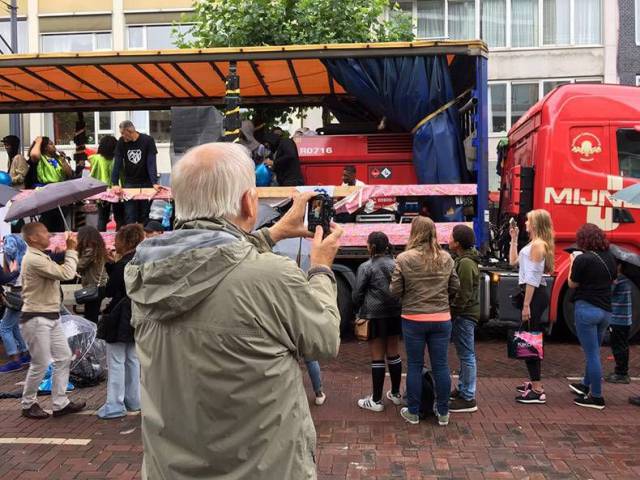 Everyone is taking pics of some street performers on a truck, and old guy is taking pictures of the hot girls.