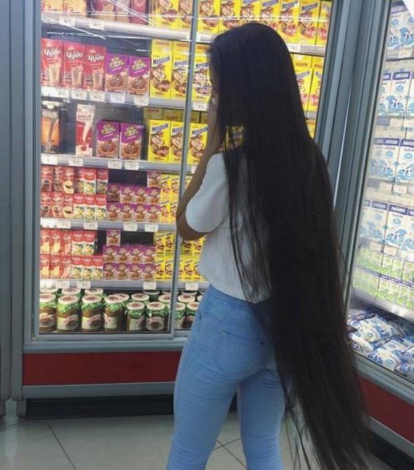 Young girl with flowing long hair in the frozen food sections