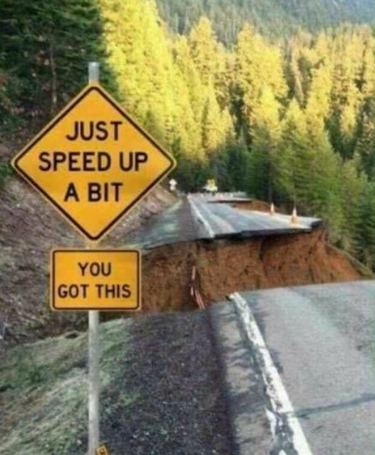 Sign egging you on to make a jump over the sinkhole that formed on the road.