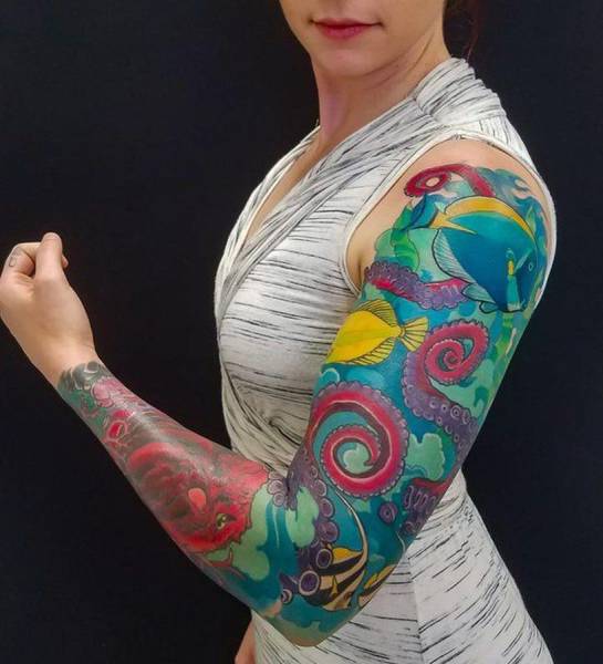 woman has a full arm of tattoos
