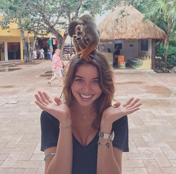 Monkey on a hot girl's head.