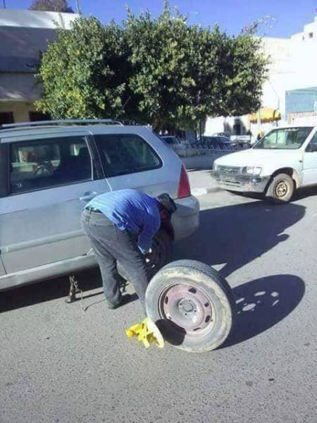 Woman changing her tire