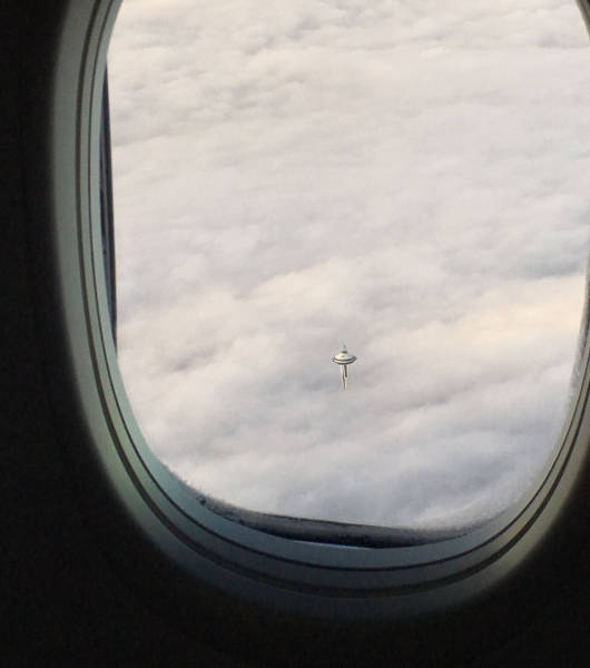 seattle space needle poking through the clouds