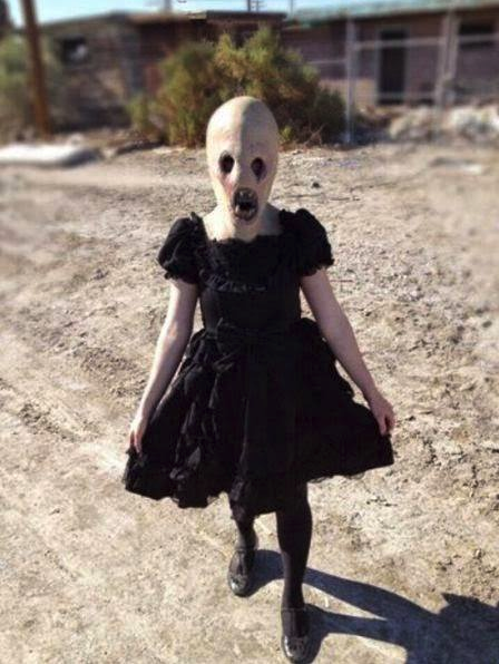 Nothing to see here. Just a totally happy-go-lucky girl out for a stroll through a dirt lot in her funeral dress. Oh yeah, she also has fangs and deep wells for eyes. No biggie.