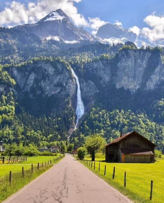 A Swiss waterfall at the end of a residential street.