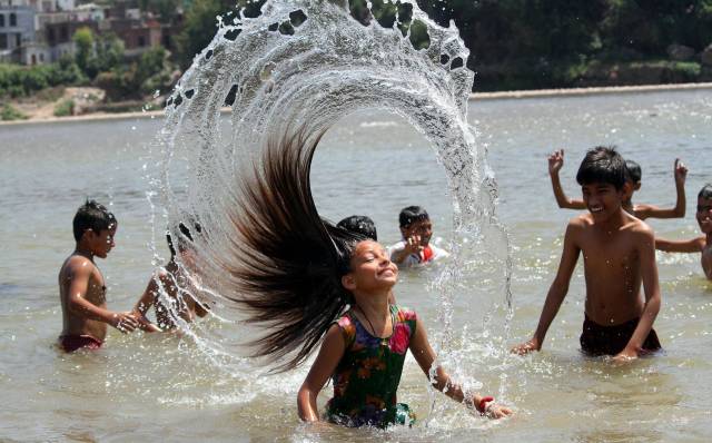 cool pic children playing in water india
