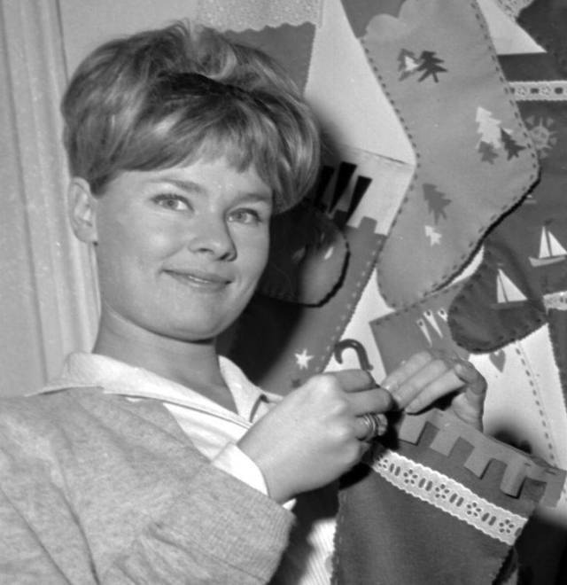 Judi Dench hanging a Christmas stocking, 1963