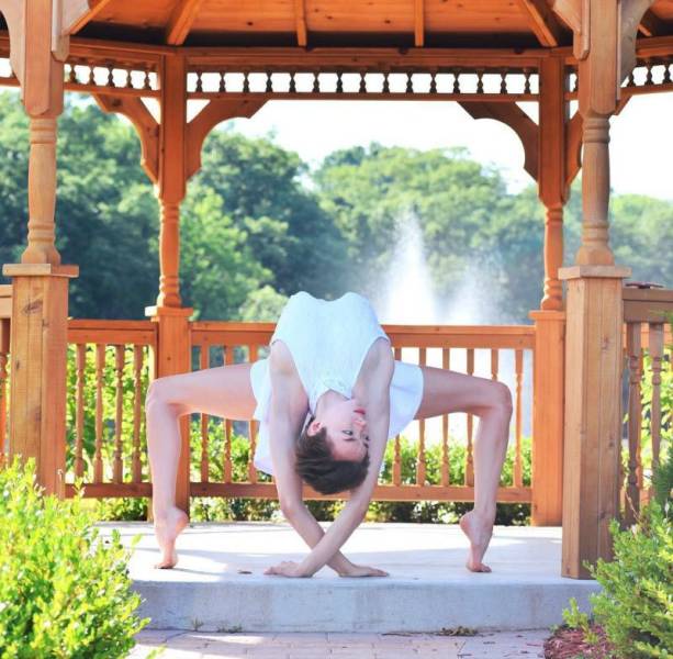 girl stretching on gazebo by the water