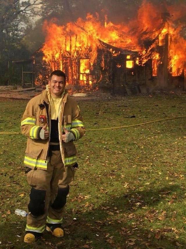 fireman standing infront of burning building