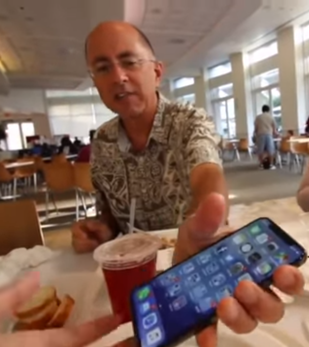 Her dad pictured at the Apple HQ in California appears to let his daughter play with the phone