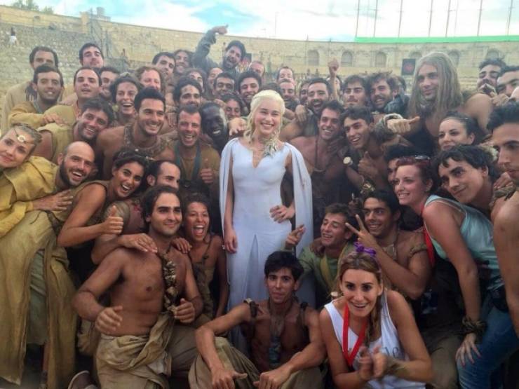 Game of Thrones behind the scenes - emilia clarke as dany surrounded by cast memebers