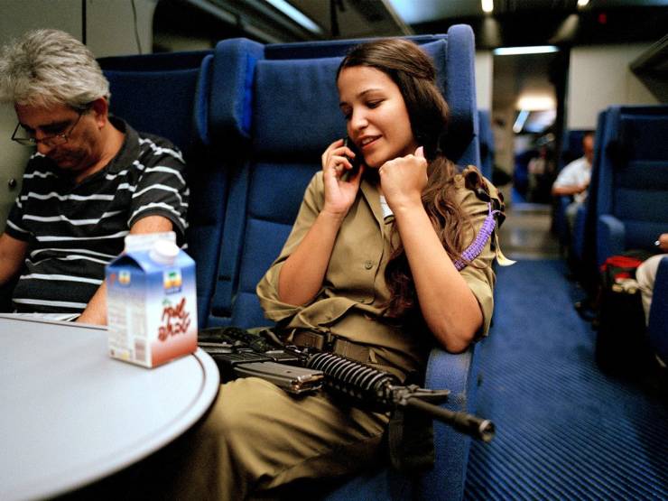 Israeli military women with gun on train