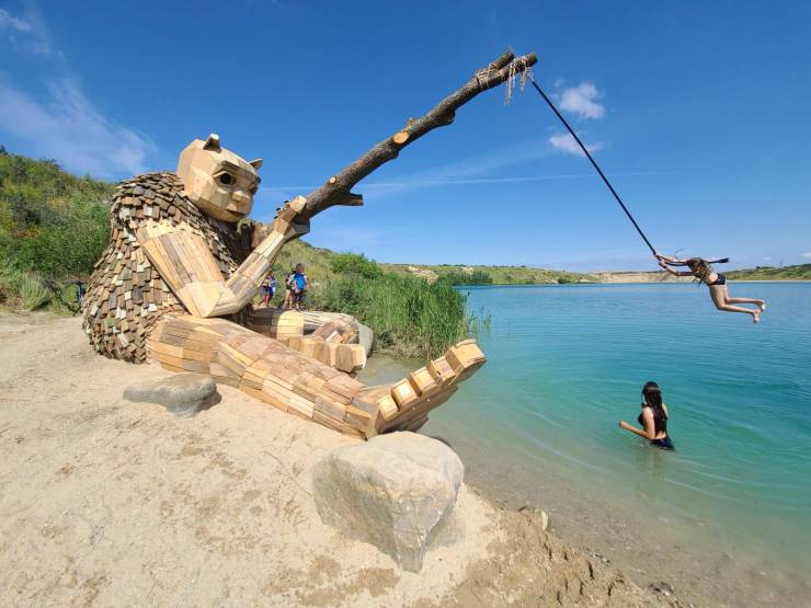 sand beach sculpture of person fishing