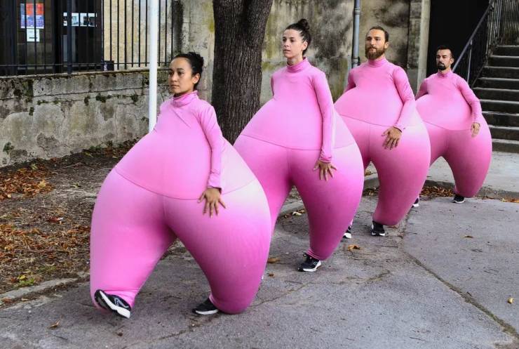 people wearing huge pink inflated suits