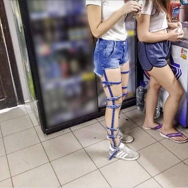 girl wearing jeans cut into little strips