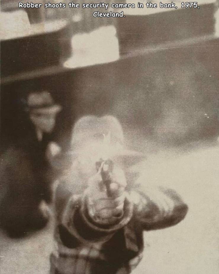 bank robber aiming at security camera cleveland ohio march 8 1975 - Robber shoots the security camera in the bank, 1975. Cleveland.